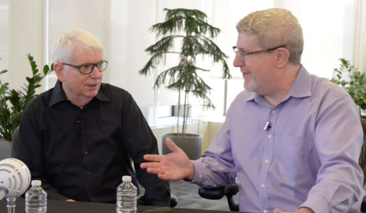 Photo of Jeff Sutherland and JJ Sutherland side by side at a desk talking