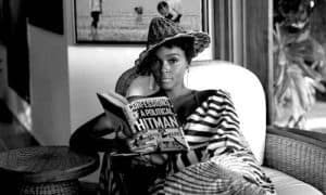 Janelle Monae reading the book Confessions of a Political Hitman.