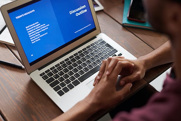 student learning online at laptop