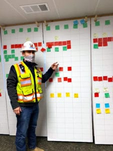 Casey Cowan Stands in front of his Scrum Board