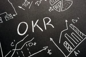OKR - Objective Key Results handwritten letters on the sheet.