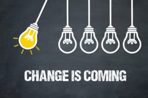 Change is coming written below a string of lightbulbs