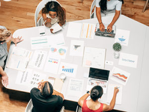 employees brainstorm around table