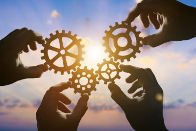 Visualizing machine cogs fitting into place. The concept of a business idea, teamwork, strategy, cooperation, and creativity.