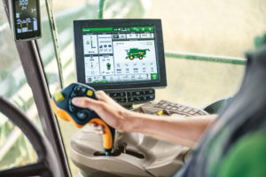 The computer interface in the driver's compartment of a John Deere combine