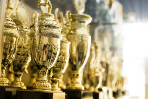 A row of championship trophies in a case