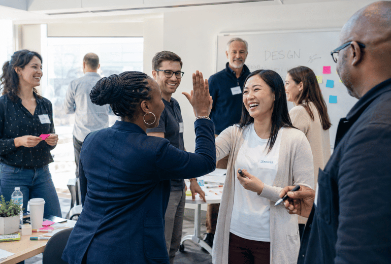 Participants celebrating during an interactive Scrum Master training workshop
